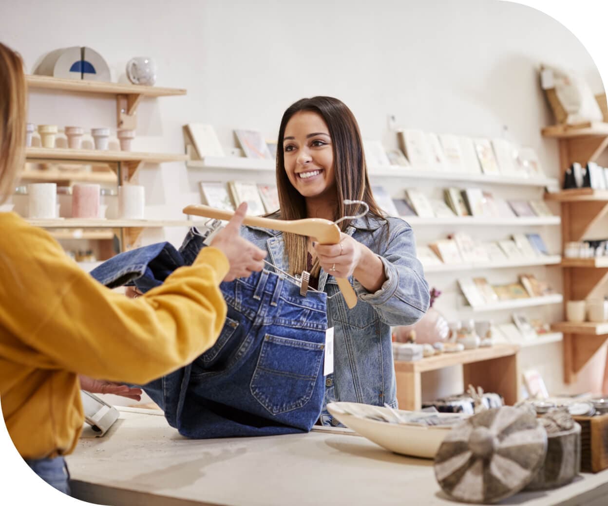 Retail worker handing a product to a customer in a retail store